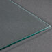A close-up of a green-edged glass panel for a Paragon popcorn popper.