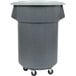 A grey plastic Continental Huskee trash can with wheels.
