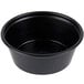 A close up of a Solo black polystyrene souffle cup.