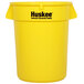 A yellow Continental Huskee trash can with a lid.