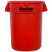 A red plastic Continental Huskee 32 gallon trash can with black text.