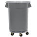 A grey plastic Continental Huskee trash can on wheels.