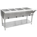 An Advance Tabco stainless steel electric steam table with an undershelf holding large stainless steel containers of food.