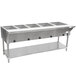An Advance Tabco stainless steel electric steam table with an undershelf holding food containers.