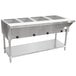 An Advance Tabco stainless steel hot food table with an open well holding food containers.