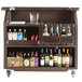 A dark brown Cambro portable bar cart with bottles of alcohol.