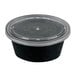 A black Newspring oval plastic souffle container with a clear lid.