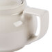 A close-up of a white Hall China teapot with a lid.