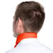 The back of a man wearing an orange chef neckerchief.