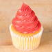 A cupcake with pink frosting with a star pattern piped on top using an Ateco French star piping tip.