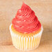 A cupcake with piped pink frosting using an Ateco French Star piping tip.