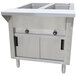 A stainless steel Advance Tabco hot food table with sliding doors over an open well.