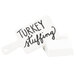 A white Cal-Mil paddle sign with black text that says "turkey stuffing" on a stand.