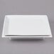A white square Cal-Mil porcelain plate with a liner on it.