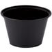A black Pactiv oval plastic souffle container with a black lid.
