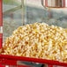 A red Carnival King container filled with popcorn.