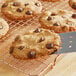 A chocolate chip cookie on a cooling rack.