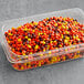 A plastic container of REESE'S Mini Pieces candy.