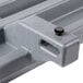 A close-up of a grey plastic tray rail bracket.