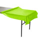 A Fresh Lime Green plastic tablecloth on a table.