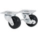 A pair of metal Hamilton Beach plate casters with black rubber wheels.