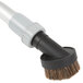 A black and white brush with a white plastic pipe attachment.