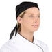 A woman wearing a black Chef Revival chef head wrap.