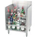 A stainless steel shelf with bottles of alcohol on a metal counter.