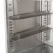 A stainless steel Advance Tabco corrugated top glass rack storage unit with two shelves and corrugated top.