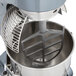 A close-up of an Avantco mixer with a metal flat beater attached.