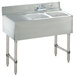 A stainless steel Advance Tabco underbar sink with two bowls and a drainboard.