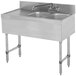 A stainless steel Advance Tabco underbar sink with two bowls and a faucet on the right side.