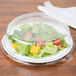 A salad in a plastic container with a WNA Comet PET lid on a plate.