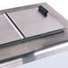 A stainless steel rectangular lid with a black handle.