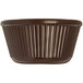A brown fluted ramekin with a white background.