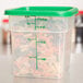 A Cambro translucent square polypropylene food storage container with 4 qt. capacity and measurements on the side filled with spiral pasta.
