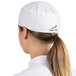A woman wearing a white Headsweats chef skull cap with a ponytail.