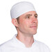 A man wearing a white Headsweats chef skull cap.