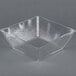 A clear square styrene bowl.