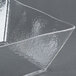 A clear American Metalcraft square styrene bowl on a gray surface.