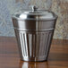 An American Metalcraft stainless steel round canister with a lid on a table.