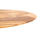 An American Metalcraft oval olive wood serving board on a table.