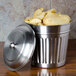 A silver American Metalcraft mini trash can lid on a metal canister full of chips.