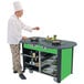 A chef cooking food on a Lakeside stainless steel induction cooking cart with green laminate finish.