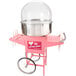 A pink Carnival King cotton candy cart with a large silver bowl.