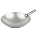 A silver Vollrath carbon steel wok pan with a handle.
