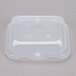 A clear plastic Vollrath steam table food pan lid on a clear plastic container.