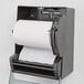 A Lavex white hardwound paper towel roll in a dispenser.