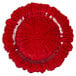 A red glass Charge It by Jay round charger plate with a scalloped edge.