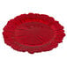 A red glass Charge It by Jay charger plate with a scalloped edge and a large flower design.